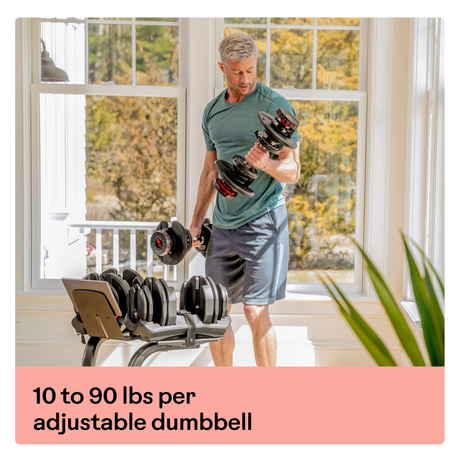 BowFlex SelectTech 1090i Adjustable Dumbbell (Single) man using both in living room