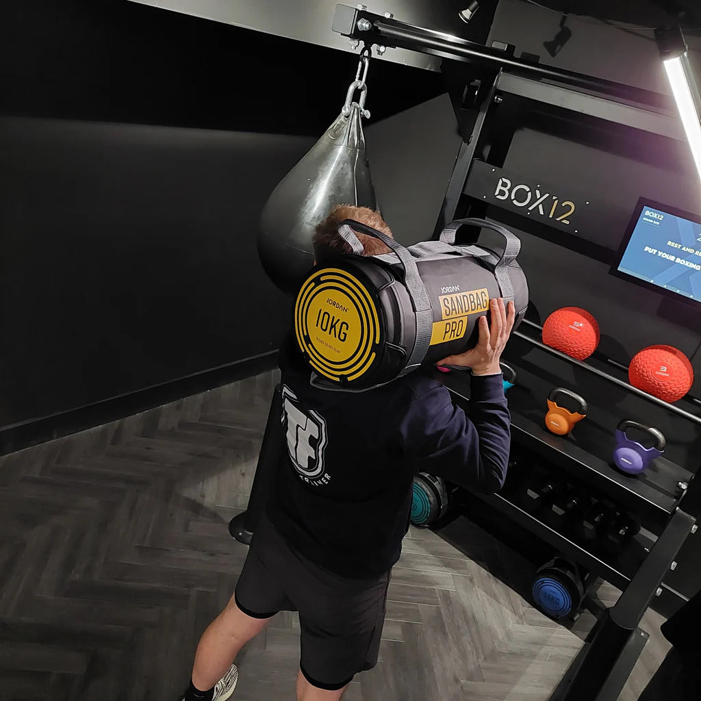  BOX12 Upclose view, with man demonstrating, screen on with Concrete wall background and loaded storage with all equipment on display