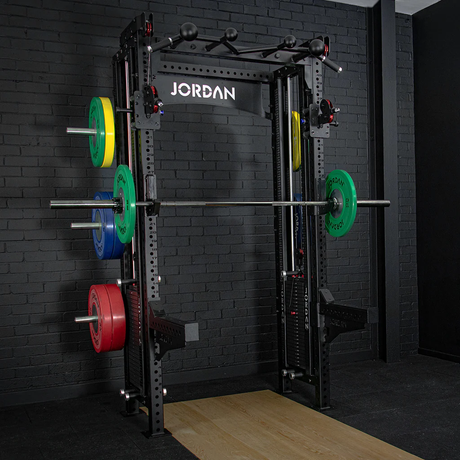 JORDAN® J75 Cable Rack Gym setting black brick background,  Barbell with Weights, Storage pegs with weights displayed, Spotter arms, Jordan olympic flooring 