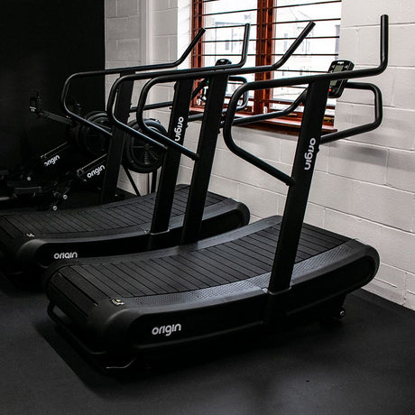 x 2 Origin Storm Curved Treadmills lined up in a Gym 