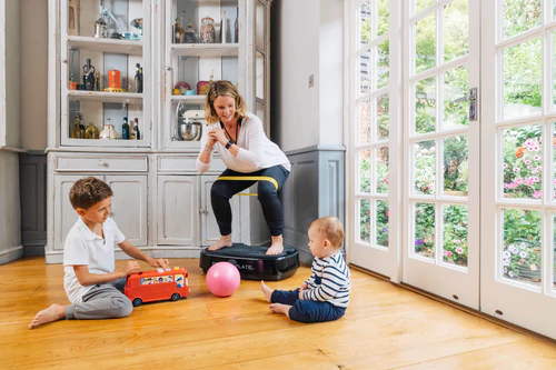 Personal Power Plate Mum using in kitchen with Children Around her
