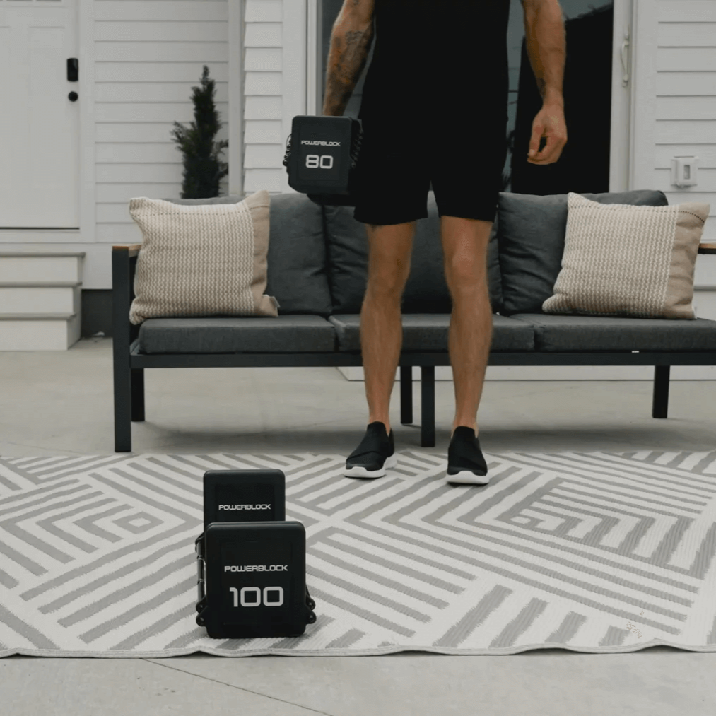 Man Performing A Workout Using The Pro100 EXP Stage 4 Adjustable Dumbbells