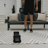 Man Performing A Workout Using The Pro100 EXP Stage 4 Adjustable Dumbbells