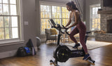 Concept 2 Bike Erg, lady using machine in living room